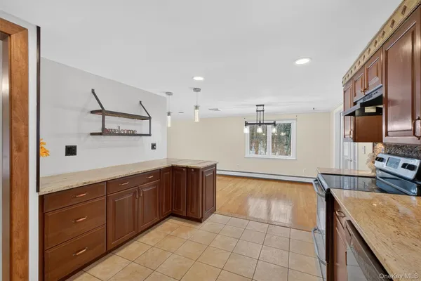 a spacious bathroom with a granite countertop sink a mirror and a bathtub