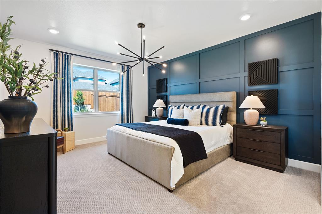 8717 Kentucky Derby Street Pilot Point, TX 76258 - Photo 7 of 18 a spacious bedroom with a bed and a chandelier