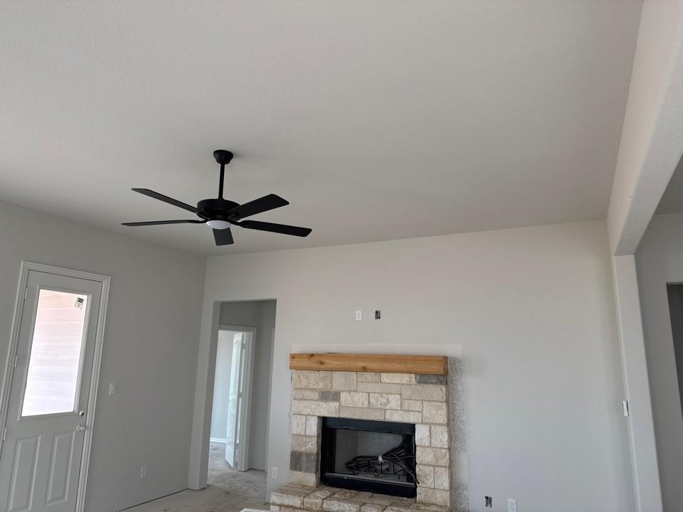 1213 Colca Drive Springtown, TX 76082 - Photo 4 of 8 Stone-faced fireplace with a natural wood mantel