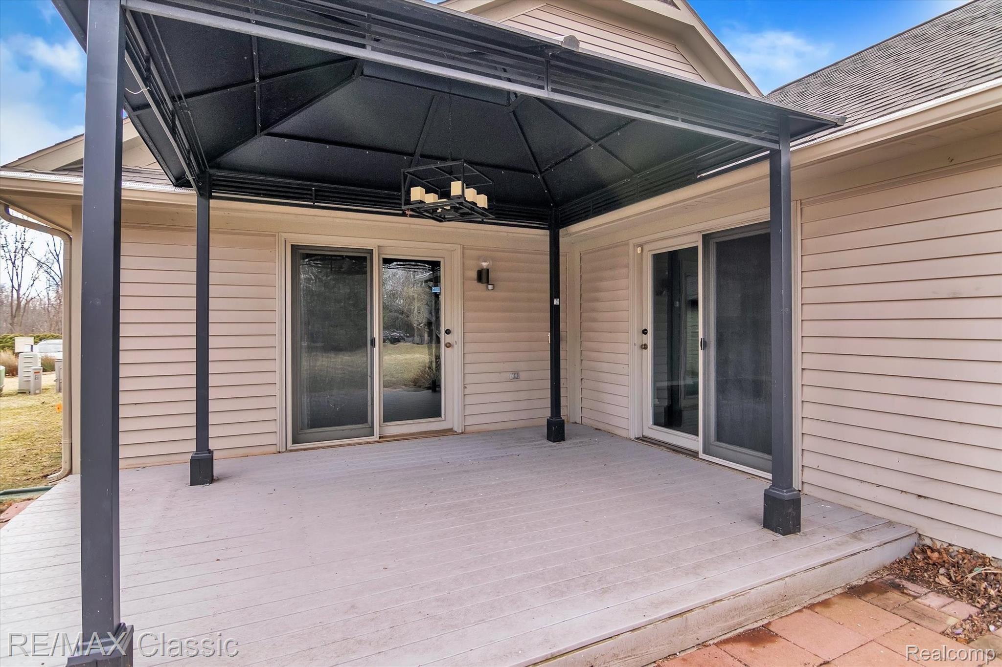 3036 Rivers Edge Drive Wayne, MI 48184 - Photo 27 of 33 The newer Trex deck with a solid year round patio cover. French Door Walls are of the Great Room and the Master Bedroom.