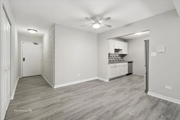 a view of a kitchen with a white cabinet and a stove top oven