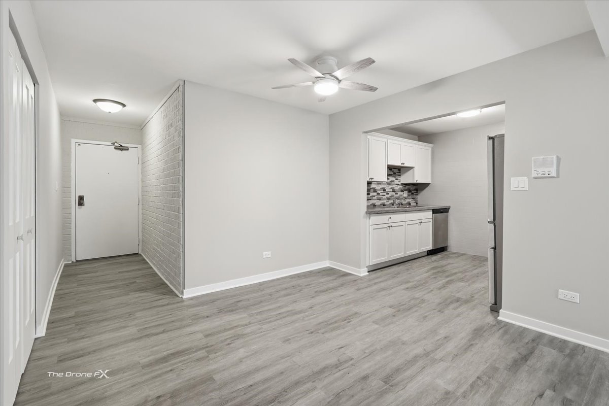 144 East Bailey Road, Unit L Naperville, IL 60565 - Photo 3 of 12 a view of a kitchen with a white cabinet and a stove top oven