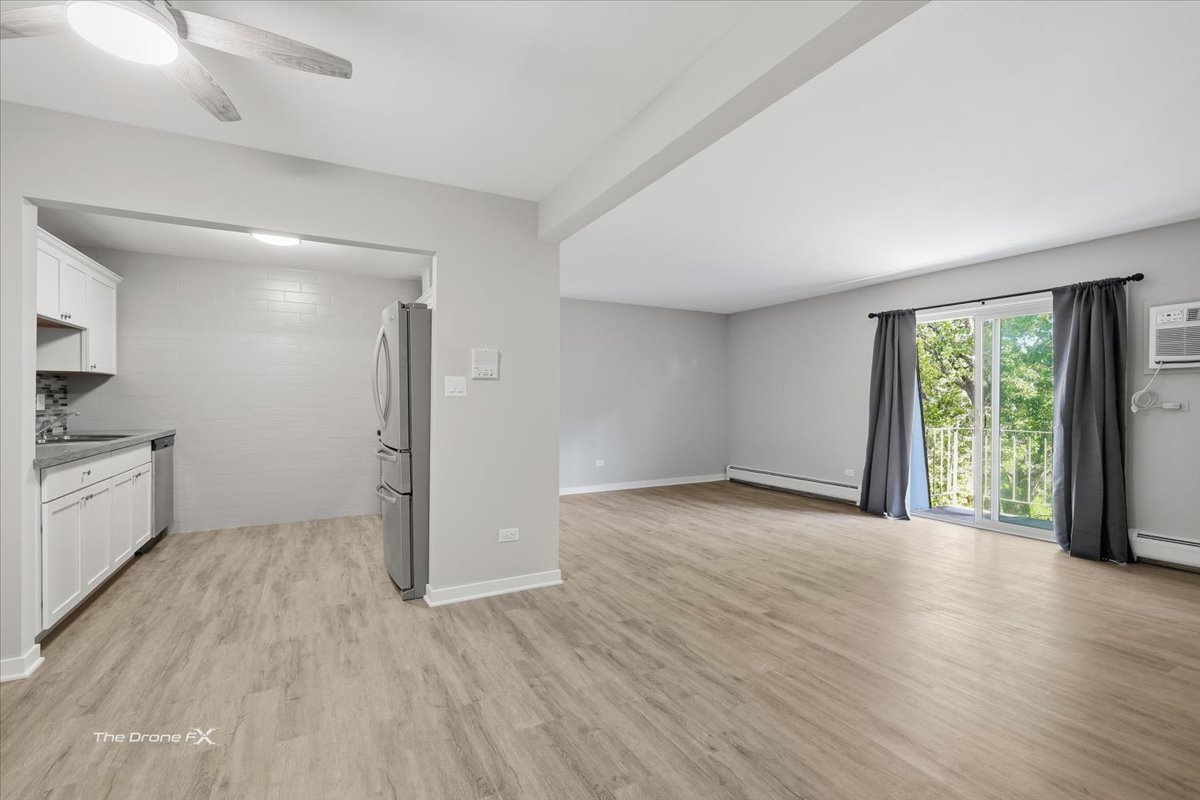 144 East Bailey Road, Unit L Naperville, IL 60565 - Photo 4 of 12 wooden floor in an empty room with a window