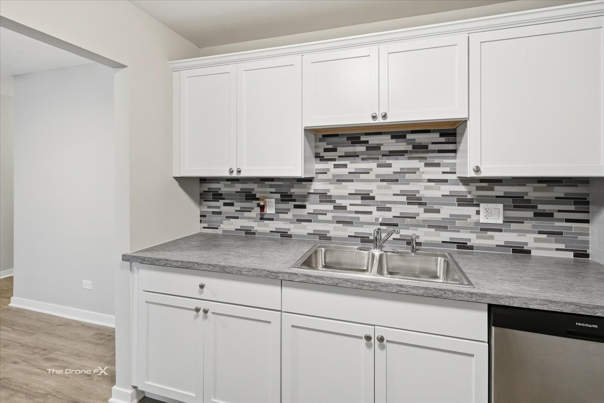 144 East Bailey Road, Unit L Naperville, IL 60565 - Photo 8 of 12 a kitchen with stainless steel appliances granite countertop a sink a stove and cabinets
