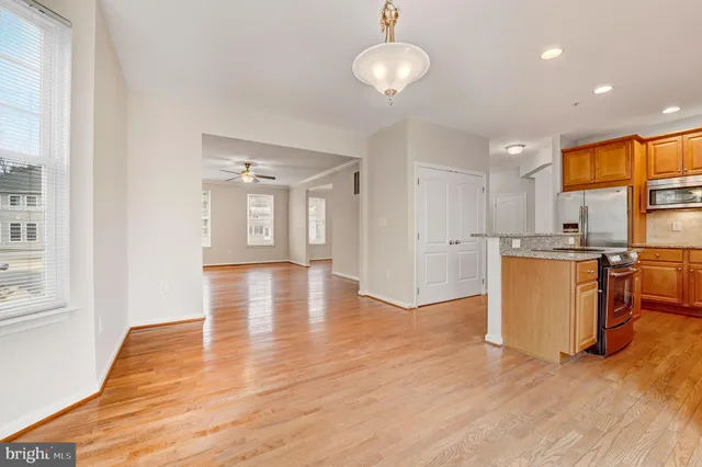 a view of a kitchen with wooden floor and a sink