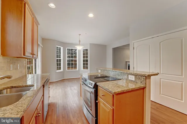 a kitchen that has a sink and a stove in it
