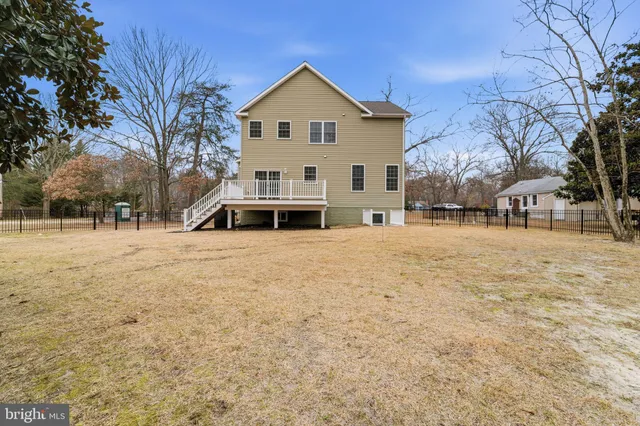 a front view of a house with a yard covered with snow