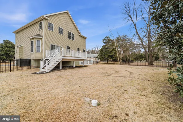 a white house that has a tree in front of it