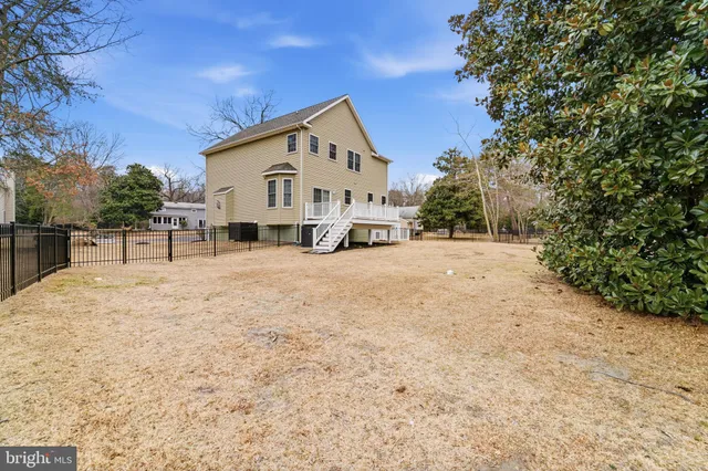 a view of a white house with a yard