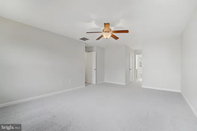 a view of room with a ceiling fan and window