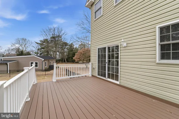 a view of a balcony with wooden floor and outdoor seating