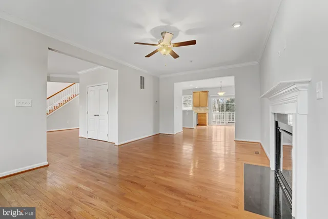 a view of empty room with wooden floor and fireplace