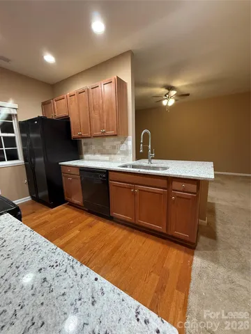 a large kitchen with kitchen island a sink stainless steel appliances and cabinets
