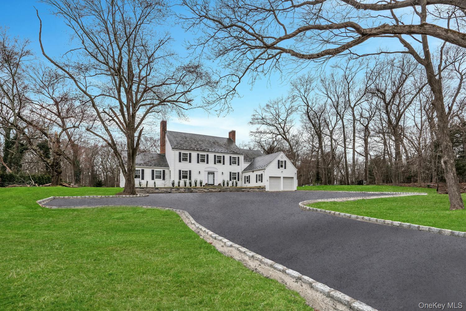 539 Split Rock Road Syosset, NY 11791 - Photo 1 of 40 Colonial inspired home with driveway, a chimney, a front yard, and a garage