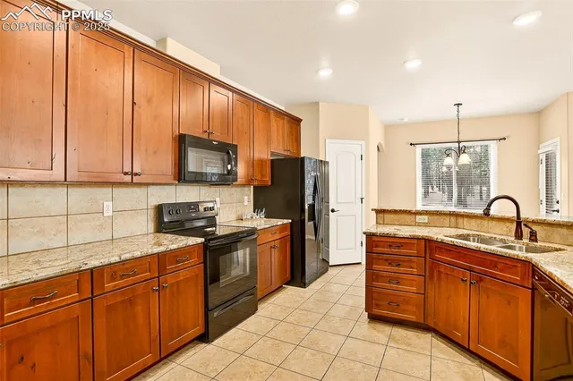a kitchen with stainless steel appliances granite countertop a stove sink and cabinets