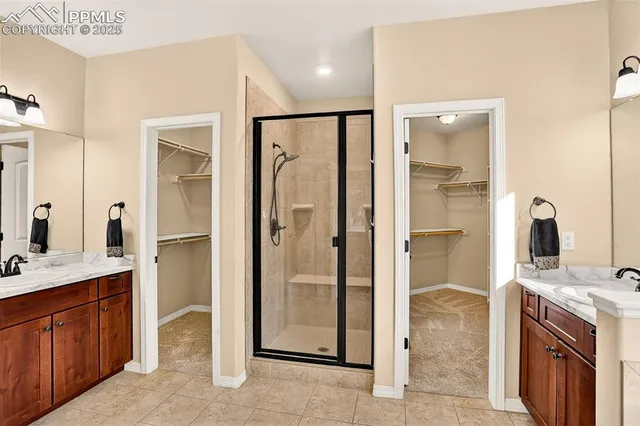 a bathroom with a granite countertop sink mirror and shower