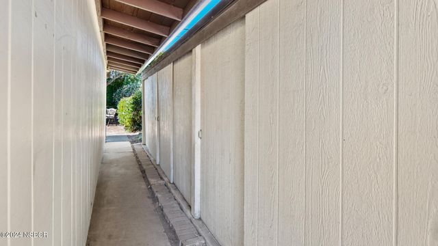 a view of a hallway with wooden floor and entryway