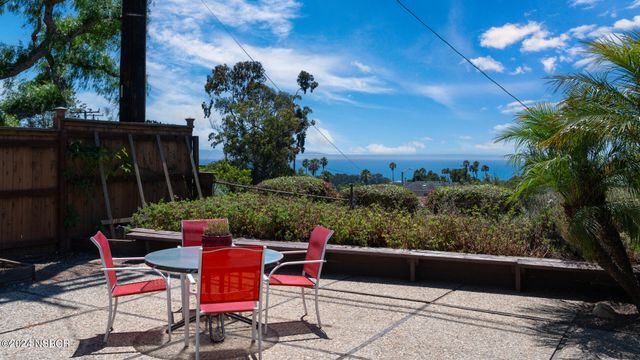 a view of a patio with couches table and chairs and potted plants