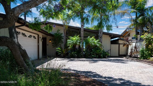 a view of house with palm trees