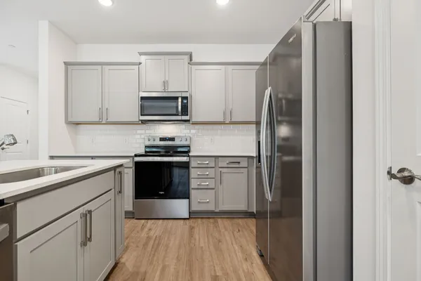 a kitchen with a refrigerator stove and microwave