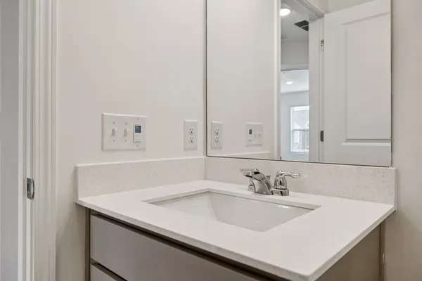 a bathroom with a sink vanity and a mirror