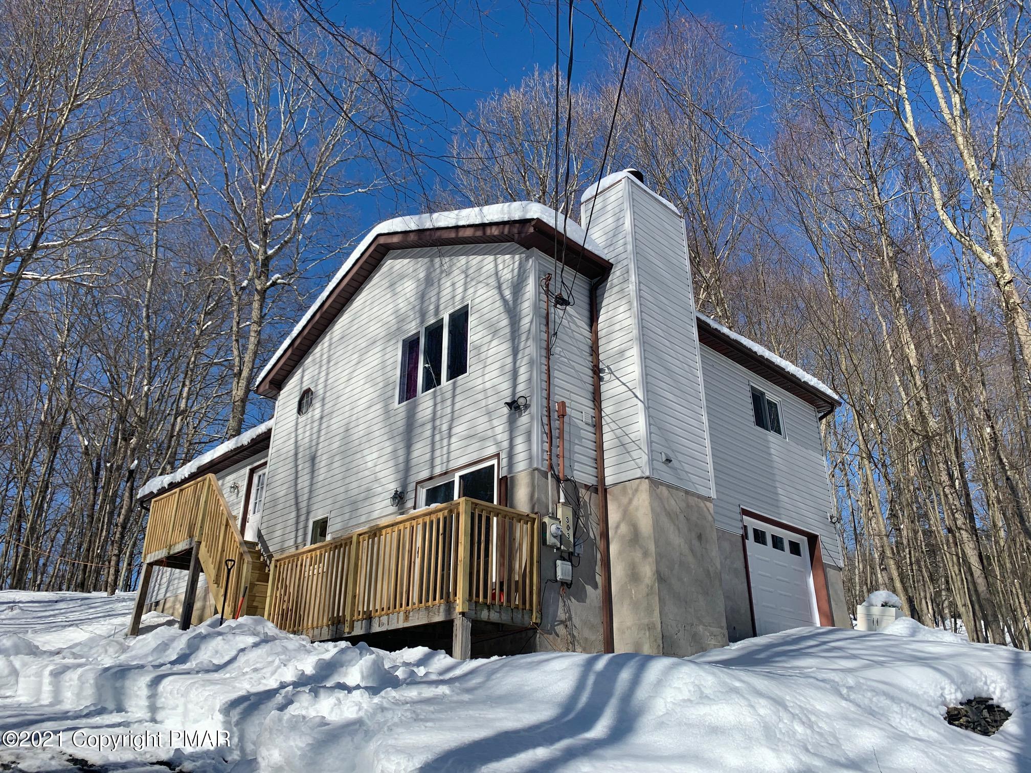 a view of a house with a wooden fence