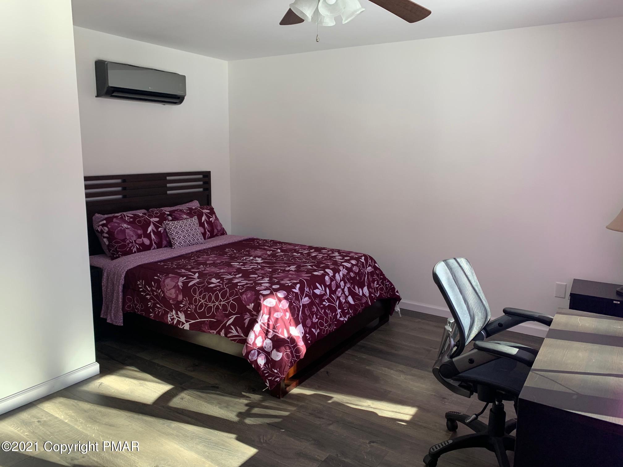 303 Otter Court Bushkill, PA 18324 - Photo 12 of 23 a bedroom with a bed a desk and chair