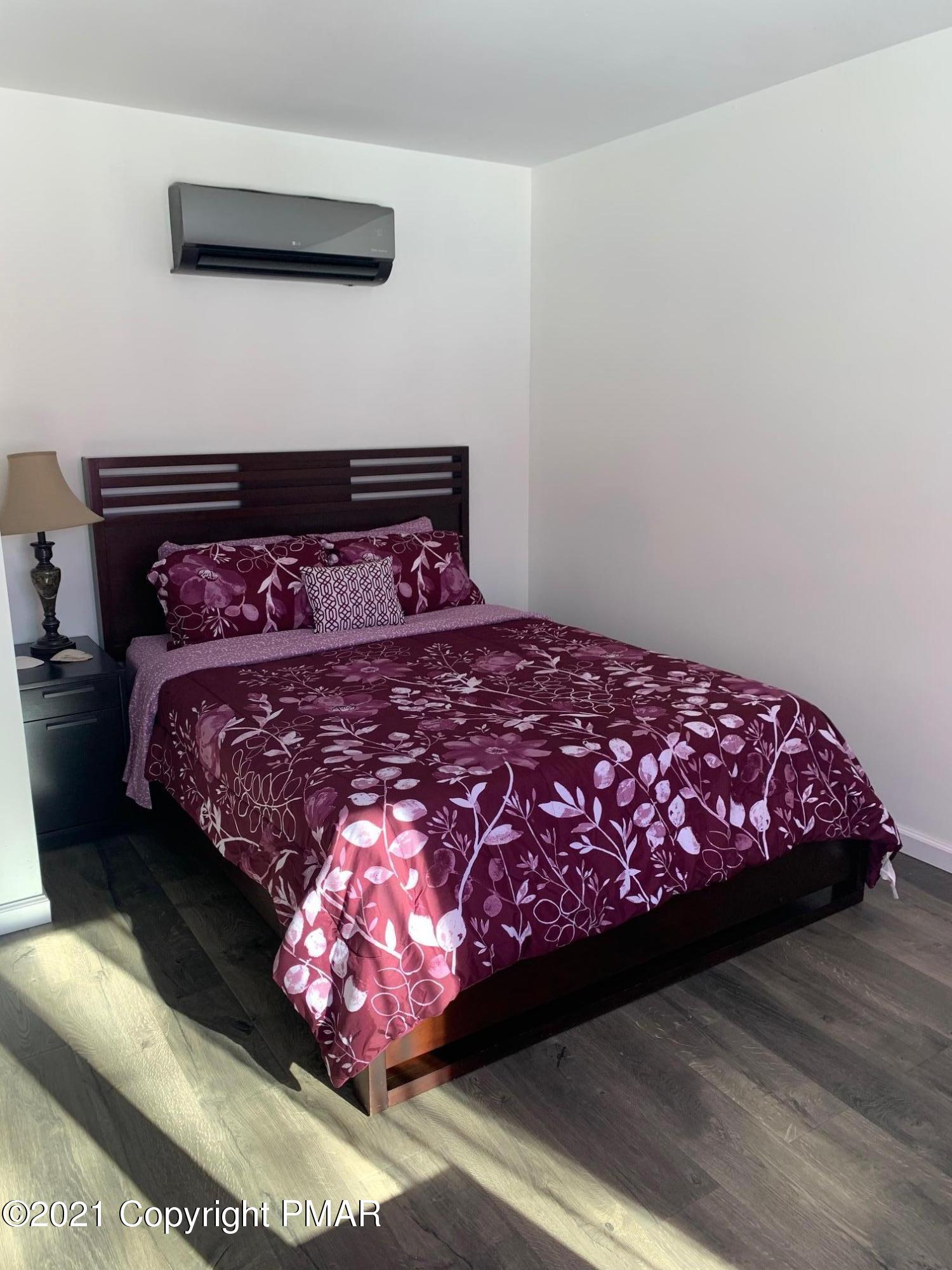 303 Otter Court Bushkill, PA 18324 - Photo 13 of 23 a bed sitting in a bedroom next to a wall