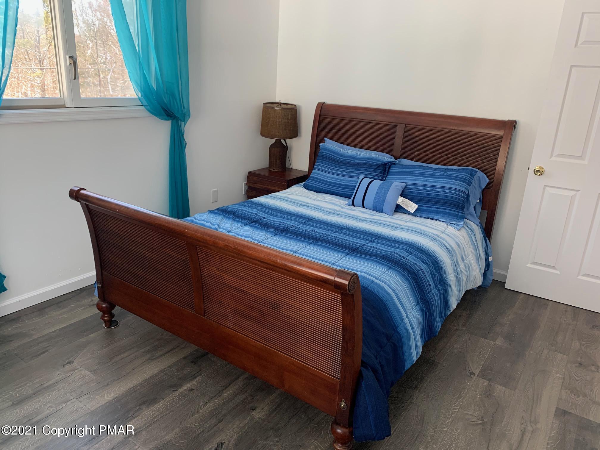 303 Otter Court Bushkill, PA 18324 - Photo 15 of 23 a bed sitting in a bedroom next to a window