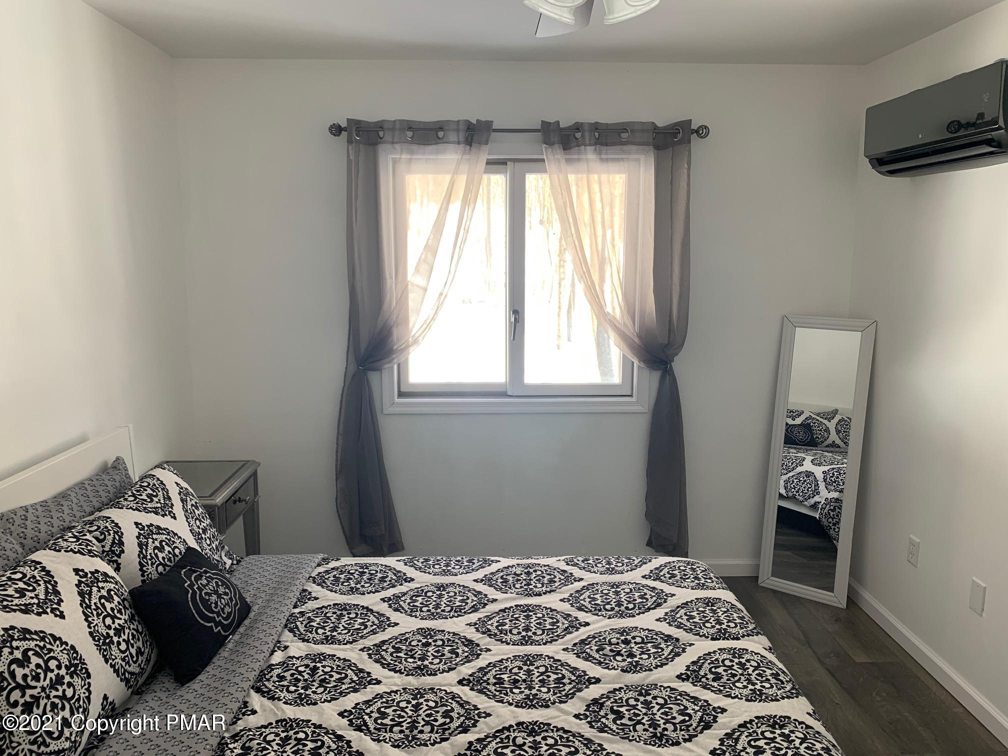 303 Otter Court Bushkill, PA 18324 - Photo 17 of 23 a bedroom with a bed and a window