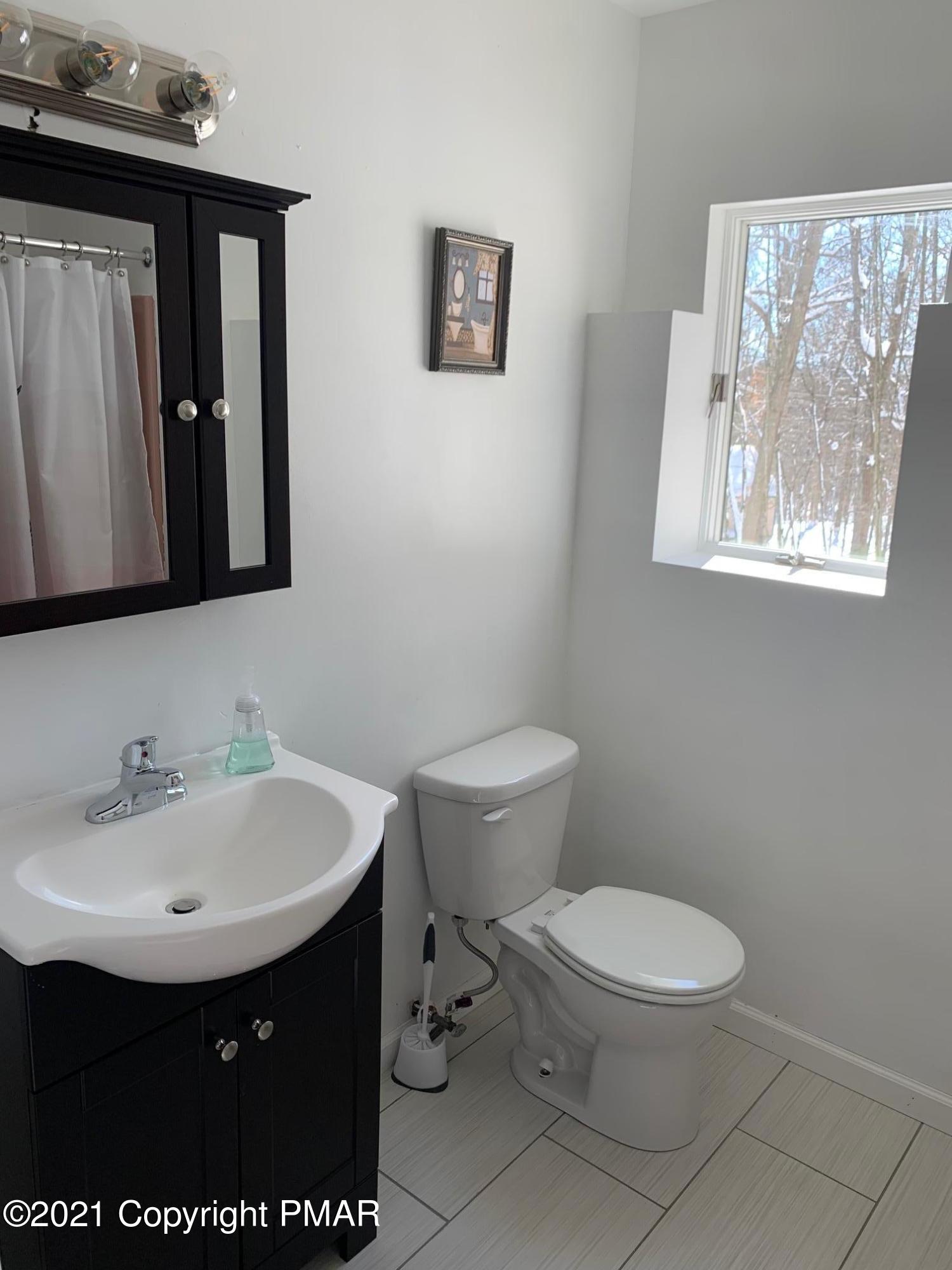 303 Otter Court Bushkill, PA 18324 - Photo 20 of 23 a bathroom with a sink toilet and mirror