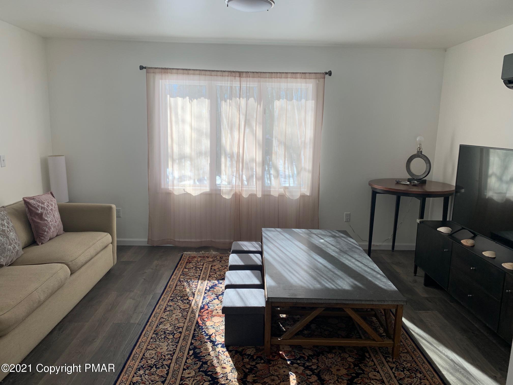 303 Otter Court Bushkill, PA 18324 - Photo 7 of 23 a bedroom with a bed and wooden floor