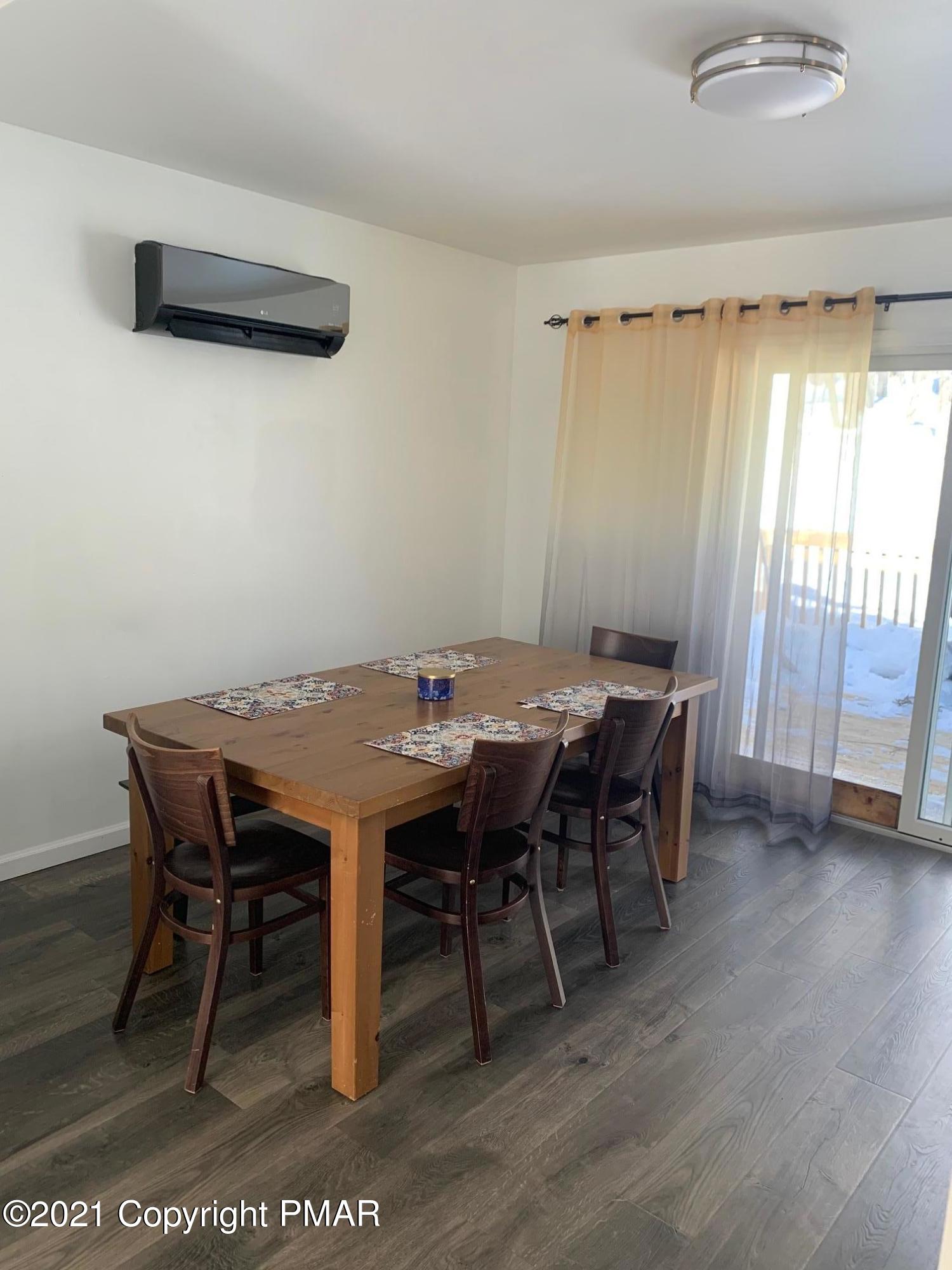 303 Otter Court Bushkill, PA 18324 - Photo 9 of 23 a view of a dining room with furniture and wooden floor