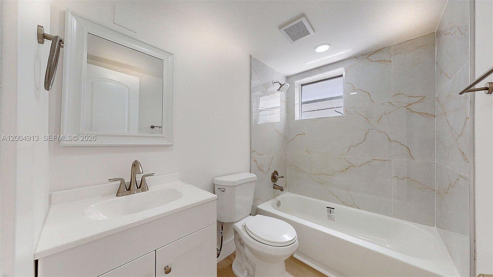 567 Southwest 3rd Street, Unit 2 Miami, FL 33130 - Photo 17 of 29 a bathroom with a sink toilet a shower and bathtub