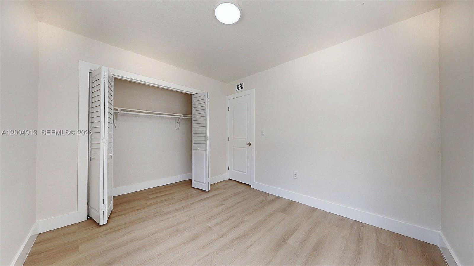 567 Southwest 3rd Street, Unit 2 Miami, FL 33130 - Photo 25 of 29 a view of an empty room with wooden floor and closet