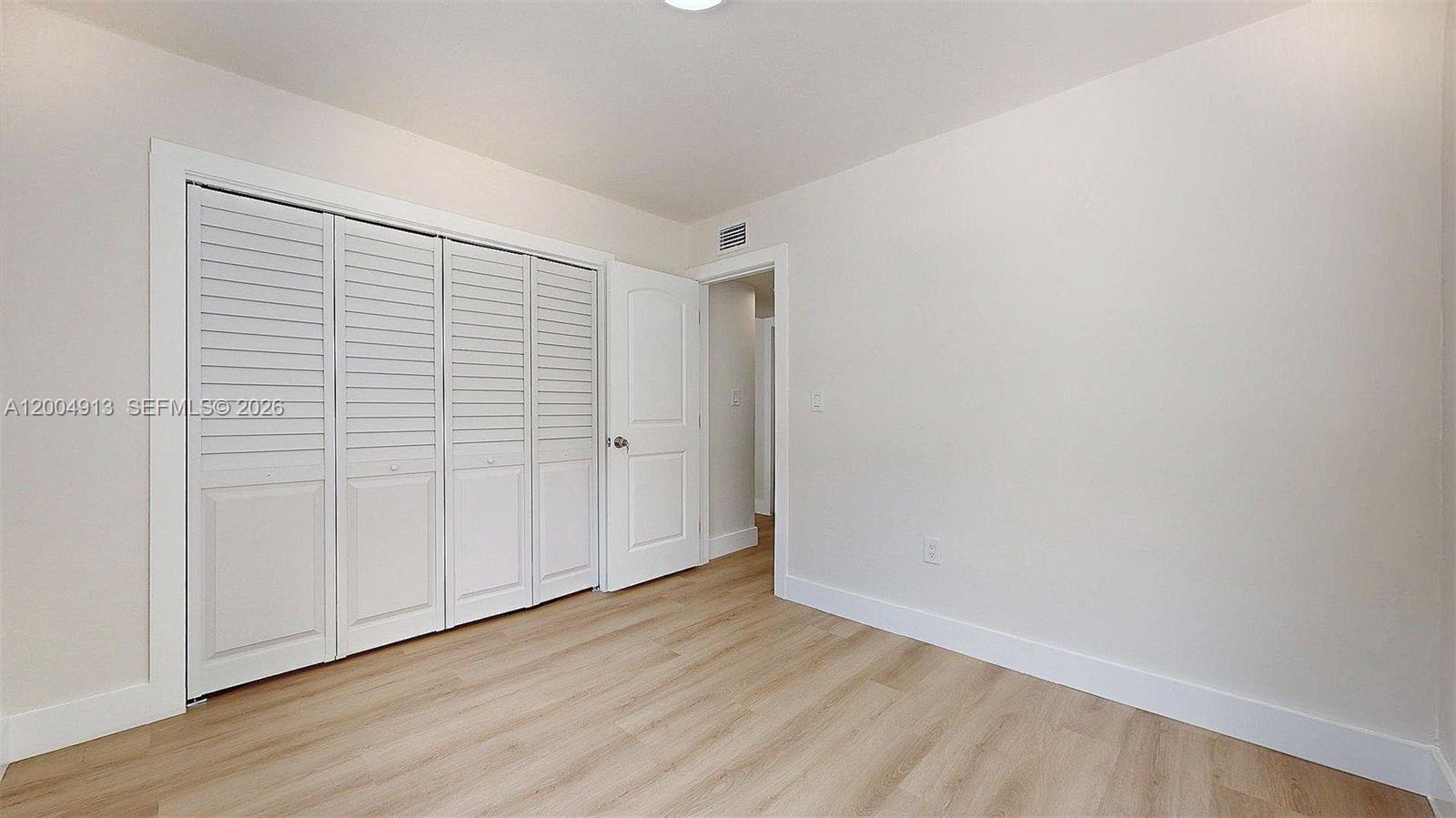 567 Southwest 3rd Street, Unit 2 Miami, FL 33130 - Photo 26 of 29 a view of an empty room with wooden floor