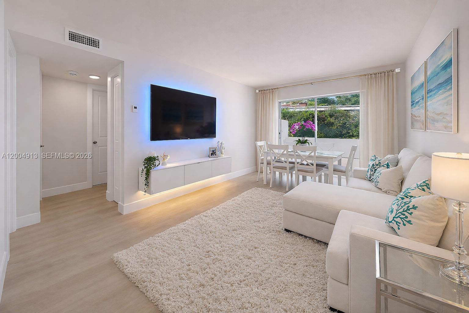 567 Southwest 3rd Street, Unit 2 Miami, FL 33130 - Photo 3 of 29 a living room with furniture and a flat screen tv