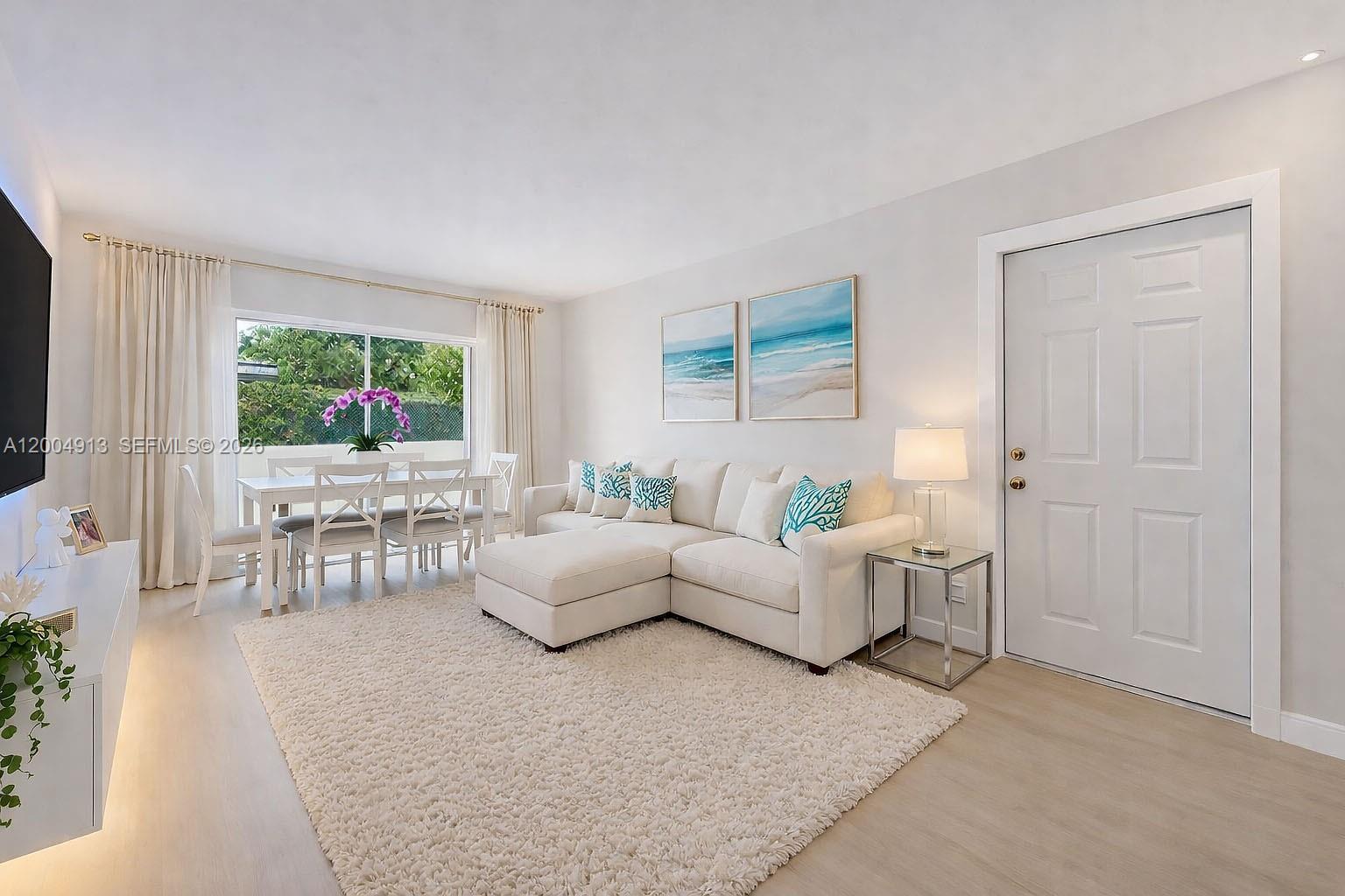 567 Southwest 3rd Street, Unit 2 Miami, FL 33130 - Photo 5 of 29 a living room with furniture and a flat screen tv
