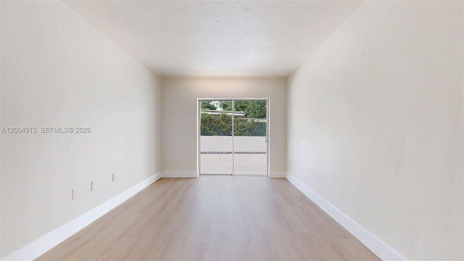 567 Southwest 3rd Street, Unit 2 Miami, FL 33130 - Photo 8 of 29 a view of a room that has wooden floor and windows in it