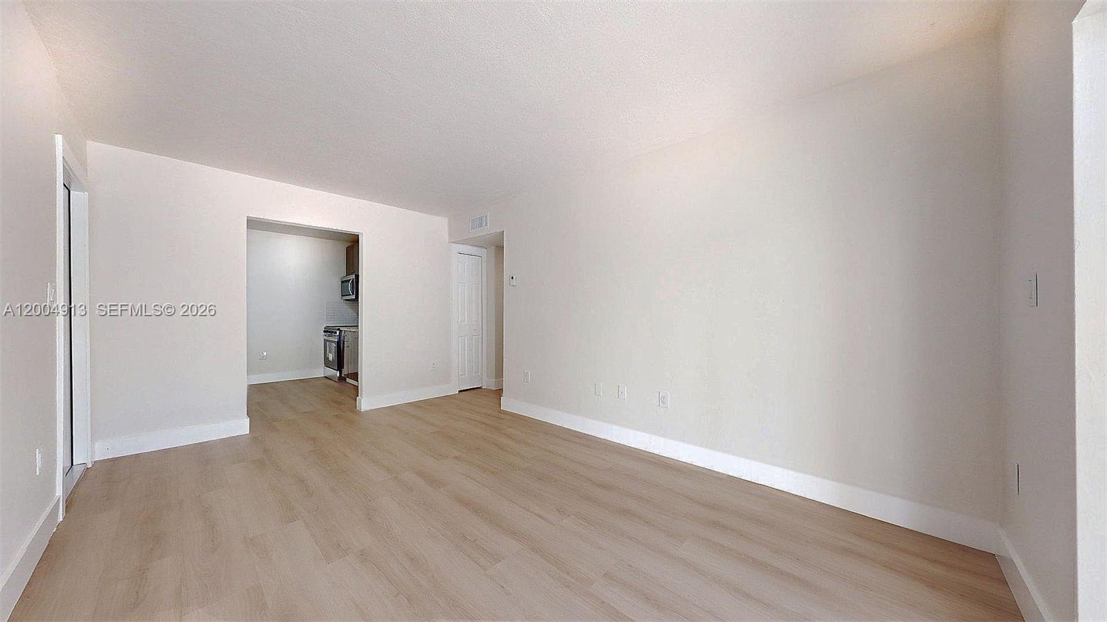 567 Southwest 3rd Street, Unit 2 Miami, FL 33130 - Photo 9 of 29 a view of an empty room with wooden floor and closet