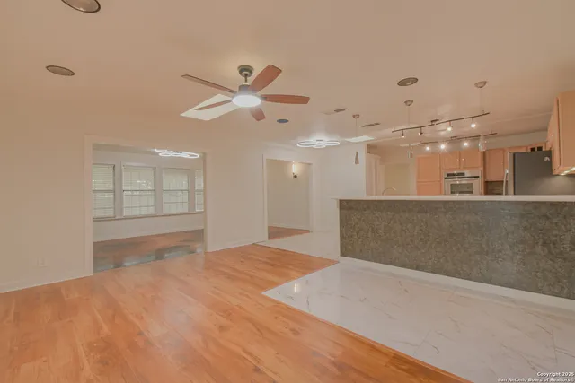 a view of an empty room with a kitchen