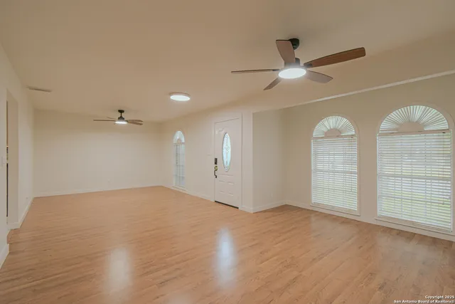 a view of kitchen and empty room