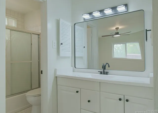 a bathroom with a shower and a toilet