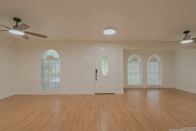 a view of kitchen with refrigerator and cabinets