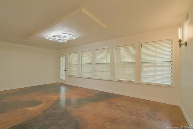 a view of an empty room with a ceiling fan