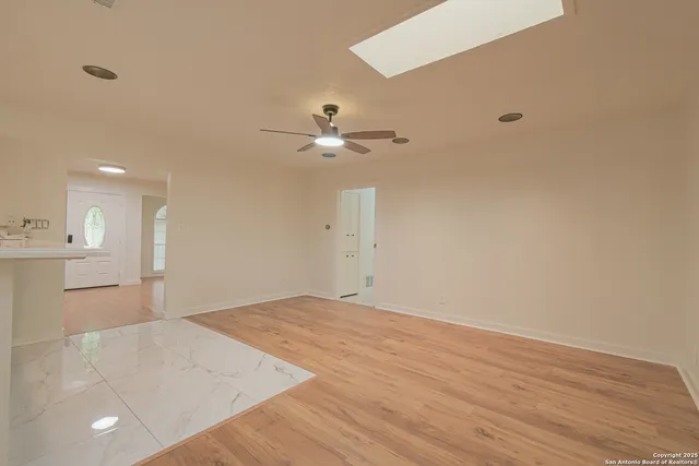 a view of a kitchen with a sink and a chandelier fan