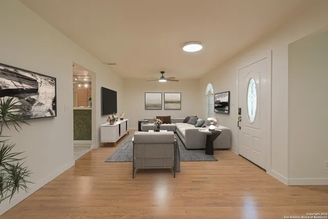 a living room with furniture and a wooden floor
