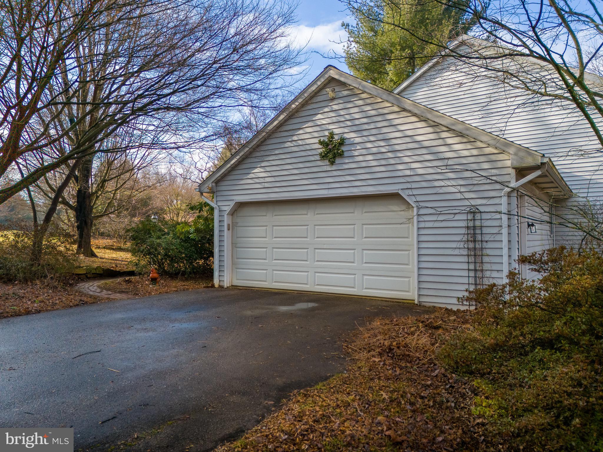 12 Phillips Lane Chester Springs, PA 19425 - Photo 13 of 54 a small white house with a white roof and table and chairs under an umbrella