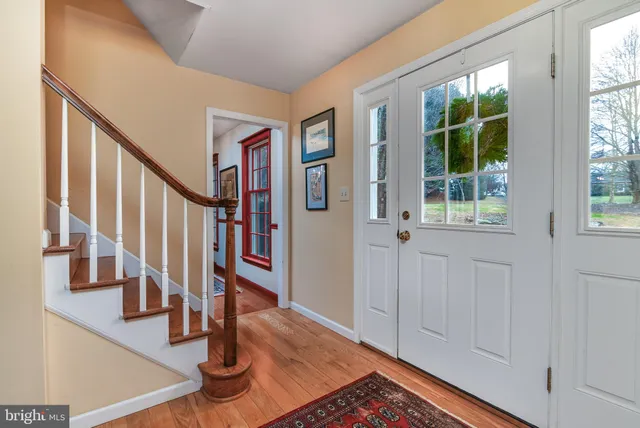 a view of entryway and hall with wooden floor