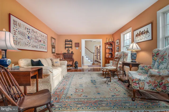 a living room with furniture and a painting on the wall
